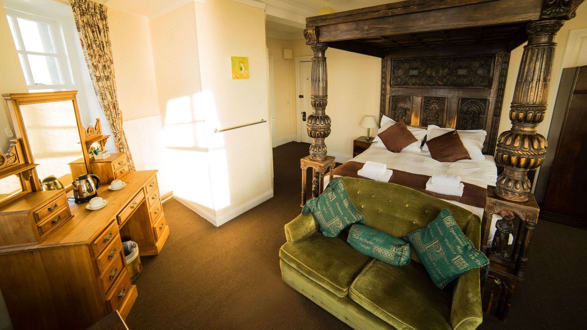 Classic Four Poster Room seating area at Camelot Castle Hotel