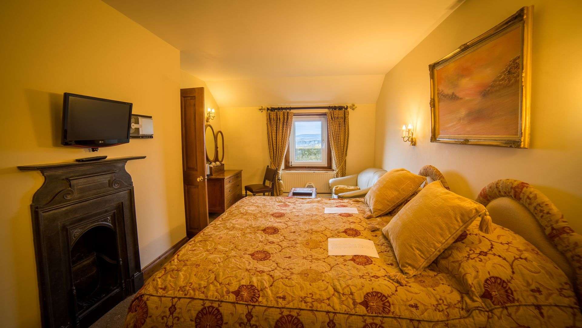 Deluxe Double Room with seating area at Camelot Castle Hotel