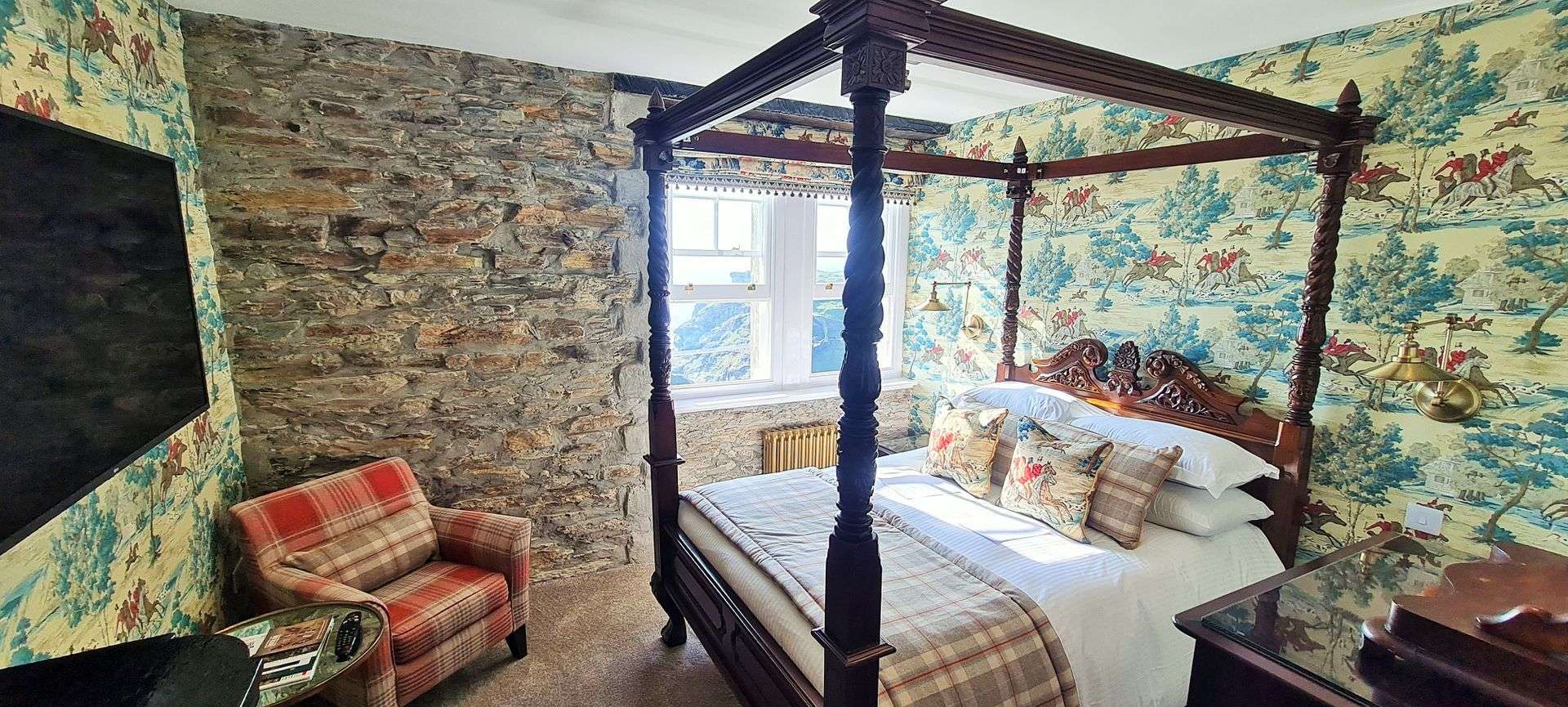 Four poster bed in the Deluxe Four Poster Room with sea view