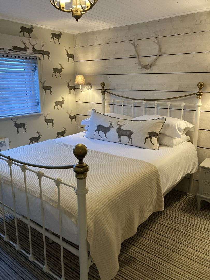 Elegant double bedroom with four poster bed and panoramic sea views