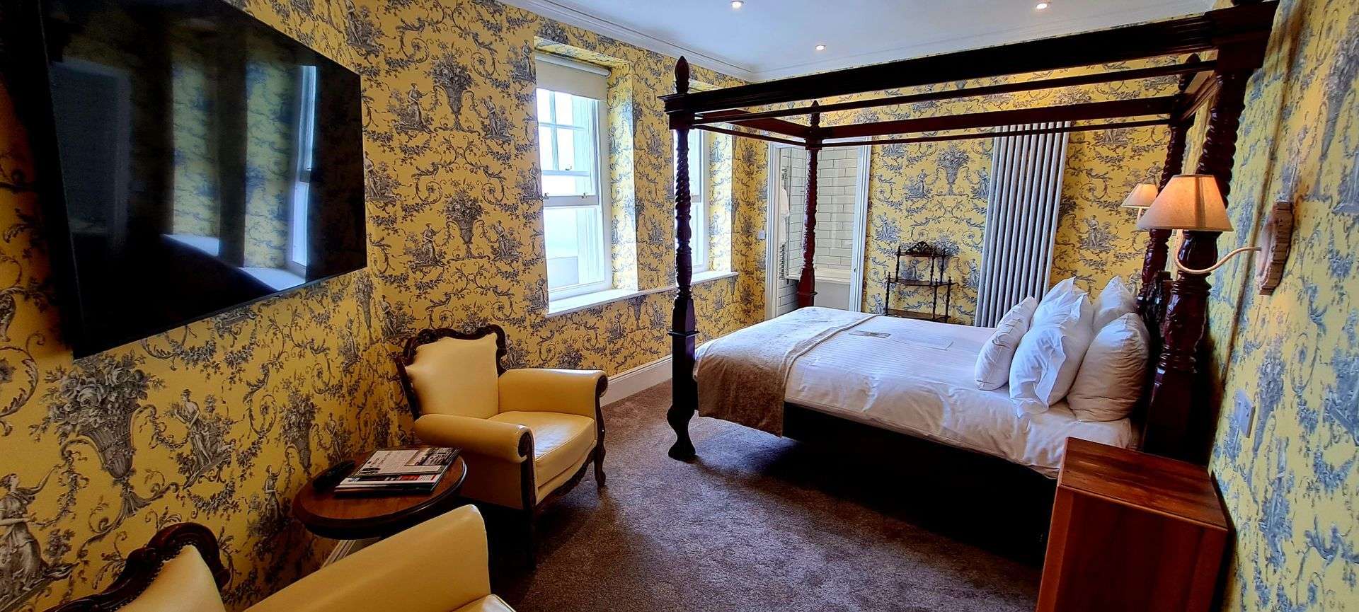 North Tower Suite bedroom with four poster bed at Camelot Castle Hotel Tintagel