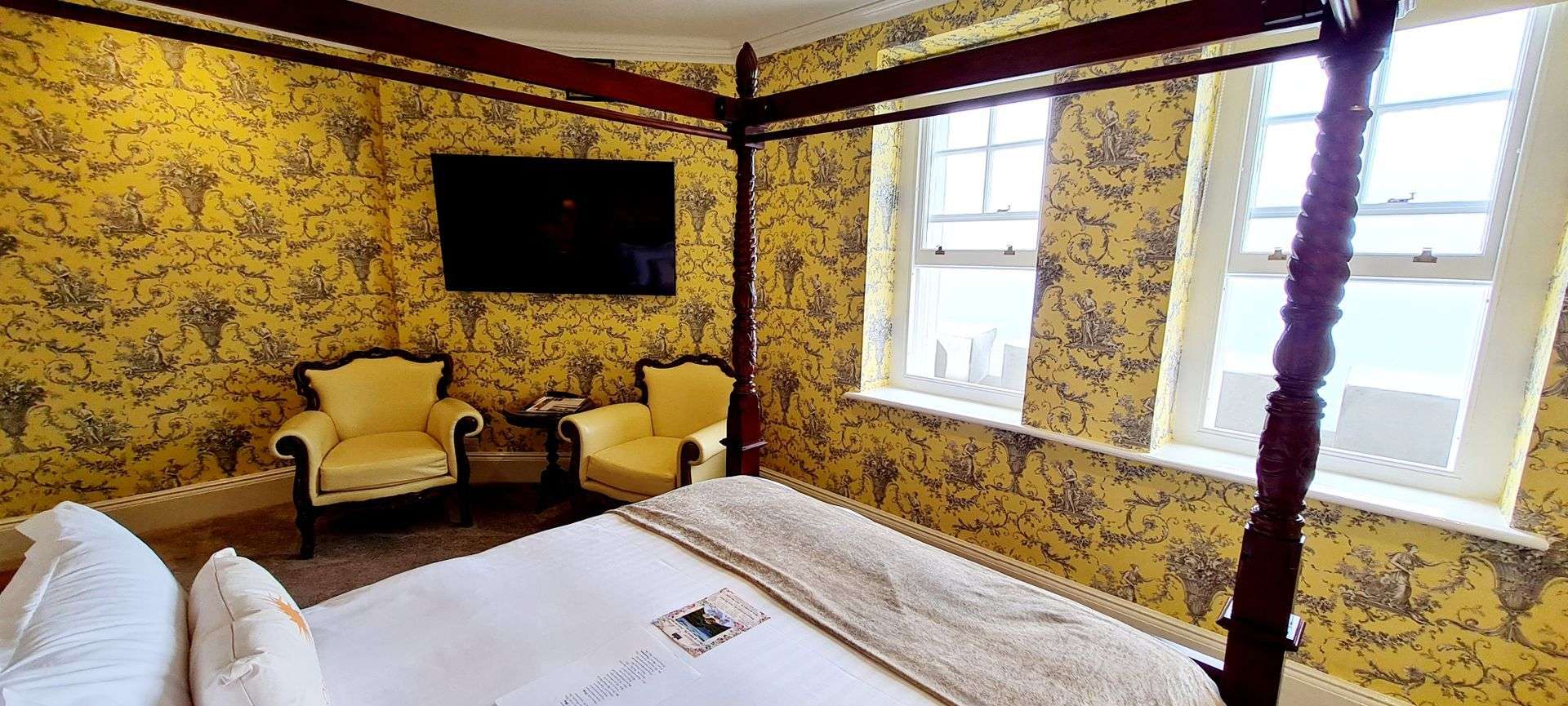 North Tower Suite bedroom with four poster bed and seating area