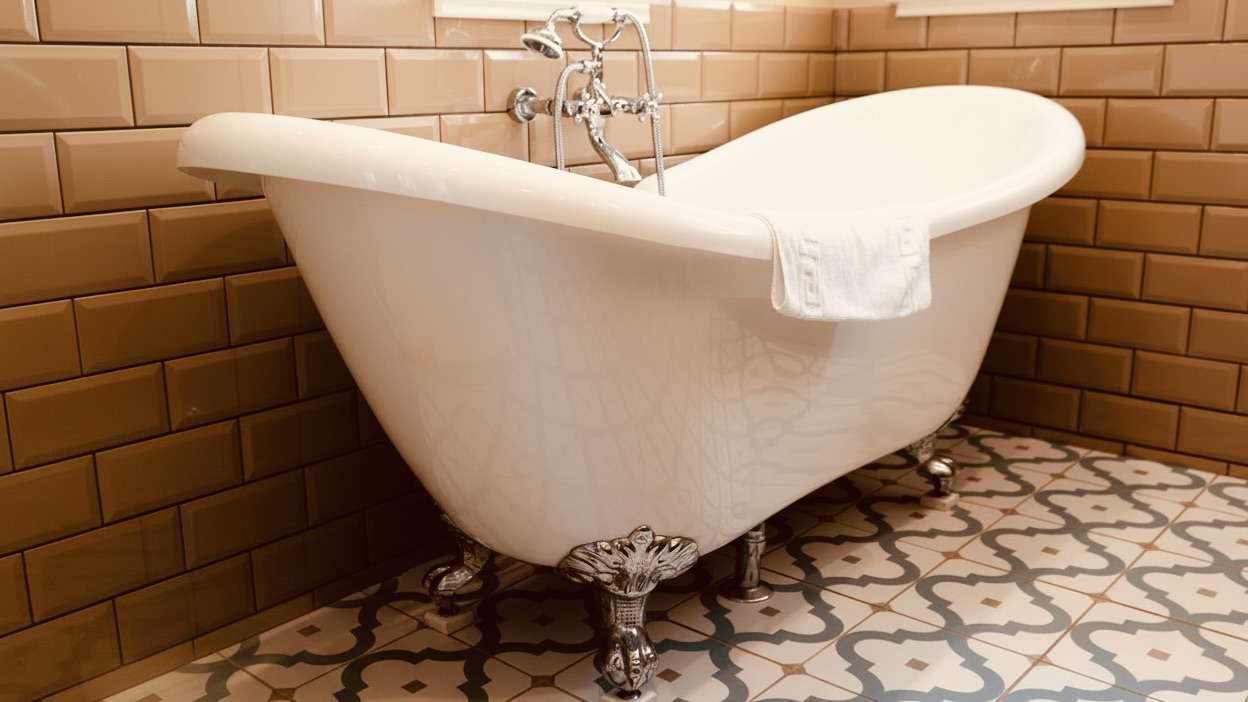 Luxury freestanding bath with vintage fittings inside Camelot Castle Hotel