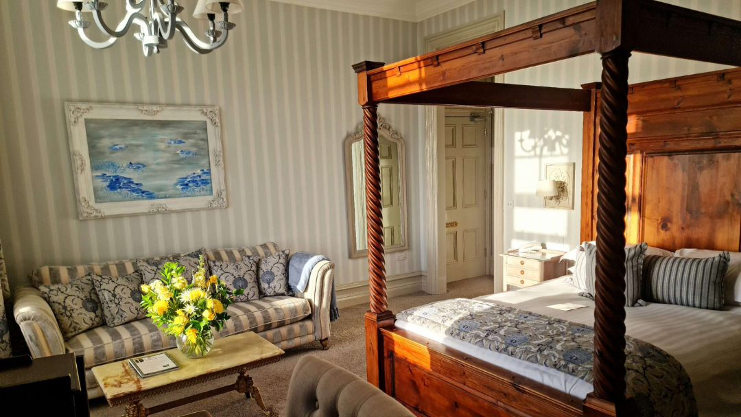 Luxury four poster bedroom at Camelot Castle Hotel with elegant furnishings