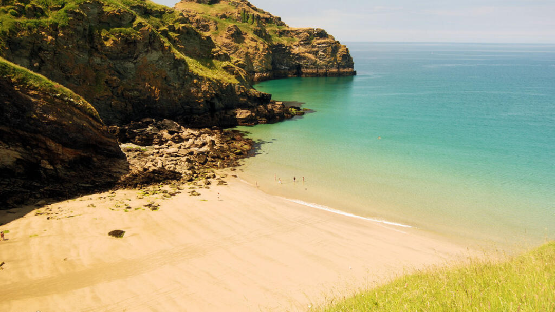 Sheltered sandy cove with turquoise water near Tintagel on the North Cornwall coast
