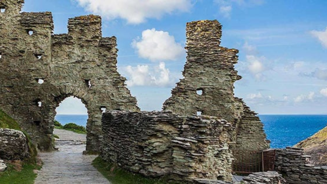 Stone archway within the ancient ruins of Tintagel Castle overlooking the sea