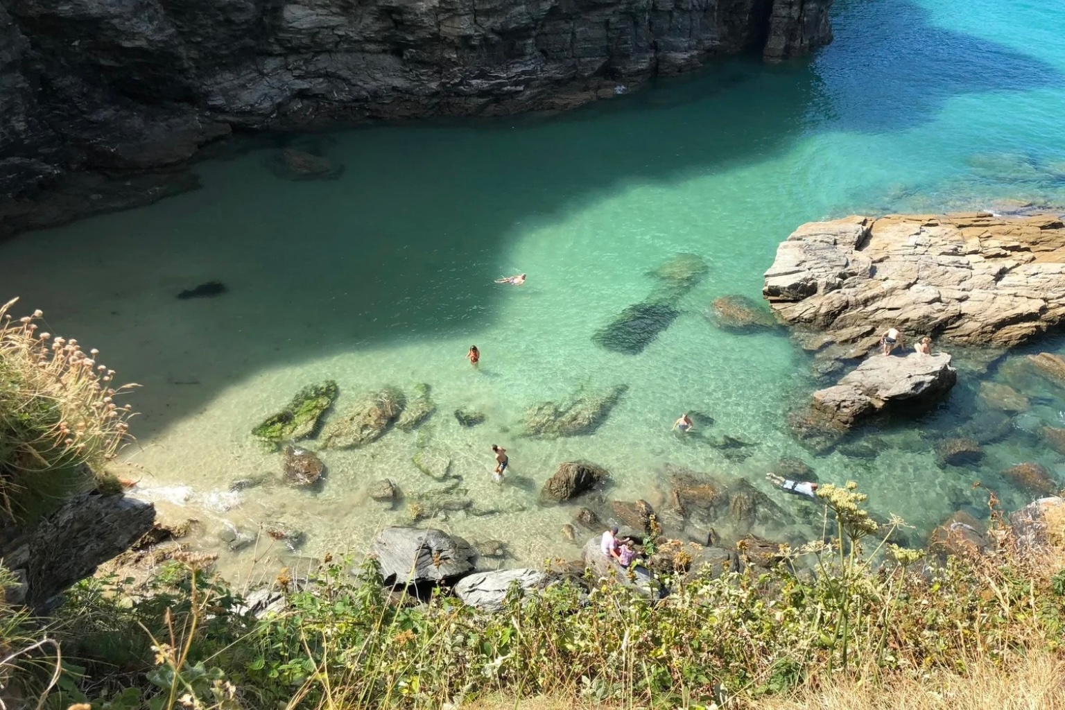 Secluded beach at Bossiney Haven near Tintagel in North Cornwall with clear turquoise water