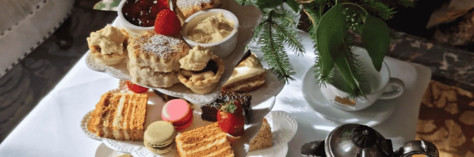 Afternoon tea with scones, cakes, sandwiches, jam and cream at Camelot Castle